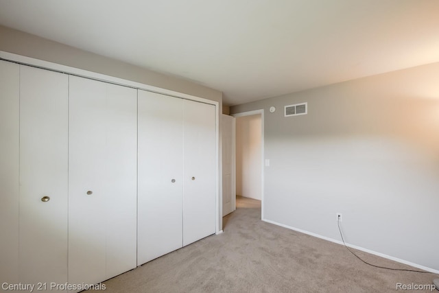 4851 Shoreline Blvd, Waterford, MI 48329 - unfurnished bedroom with a closet, light colored carpet, and baseboards