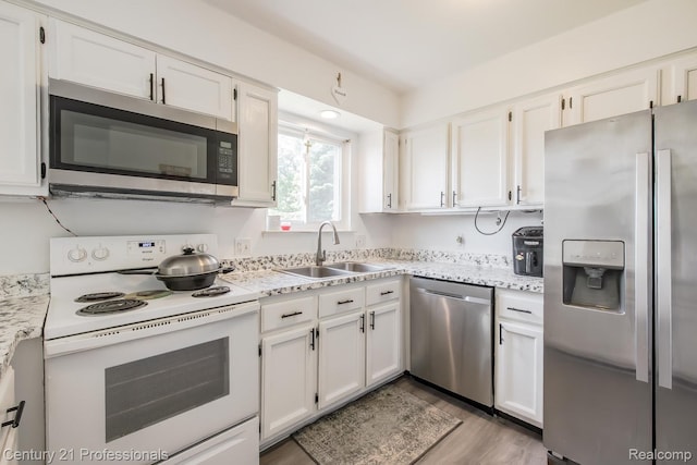 4851 Shoreline Blvd, Waterford, MI 48329 - kitchen featuring stainless steel appliances, a sink, and white cabinets
