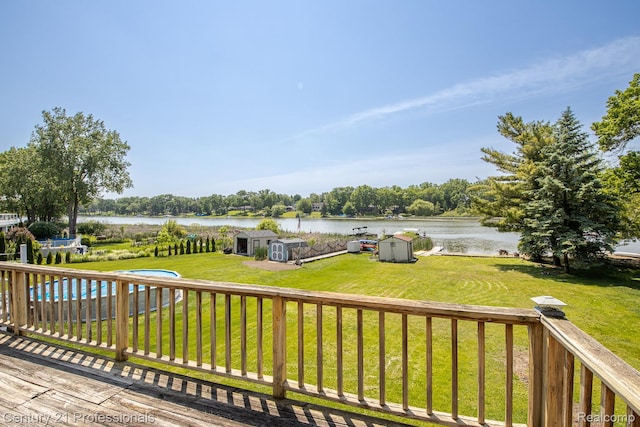 4851 Shoreline Blvd, Waterford, MI 48329 - wooden deck featuring a yard, a water view, and an outdoor pool