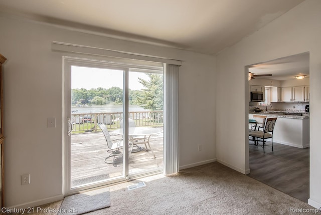 4851 Shoreline Blvd, Waterford, MI 48329 - doorway to outside featuring baseboards, a ceiling fan, carpet, and a water view