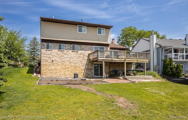4851 Shoreline Blvd, Waterford, MI 48329 - back of property with a wooden deck, brick siding, a yard, and a patio