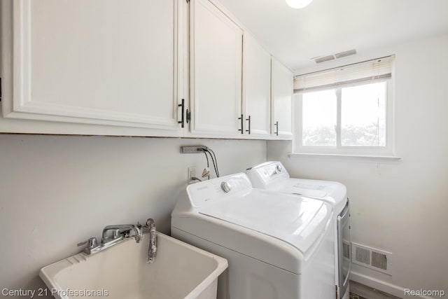 4851 Shoreline Blvd, Waterford, MI 48329 - laundry area featuring washer and dryer and cabinet space