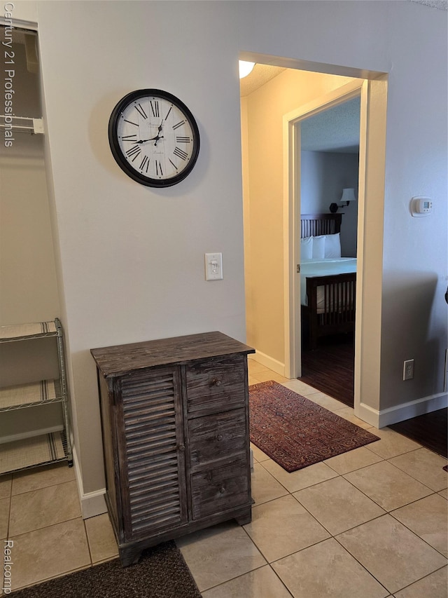 5714 N Creeks Xing, Williamsburg, MI 49690 - hall with light tile patterned floors and baseboards