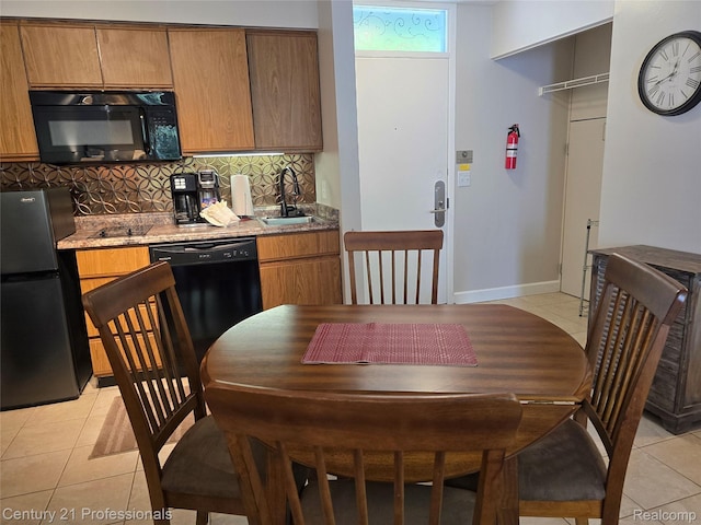 5714 N Creeks Xing, Williamsburg, MI 49690 - kitchen featuring black appliances, light tile patterned flooring, a sink, backsplash, and brown cabinetry