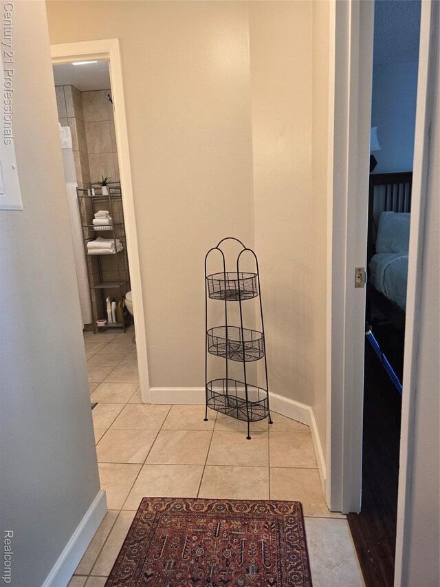 5714 N Creeks Xing, Williamsburg, MI 49690 - hallway featuring light tile patterned flooring and baseboards