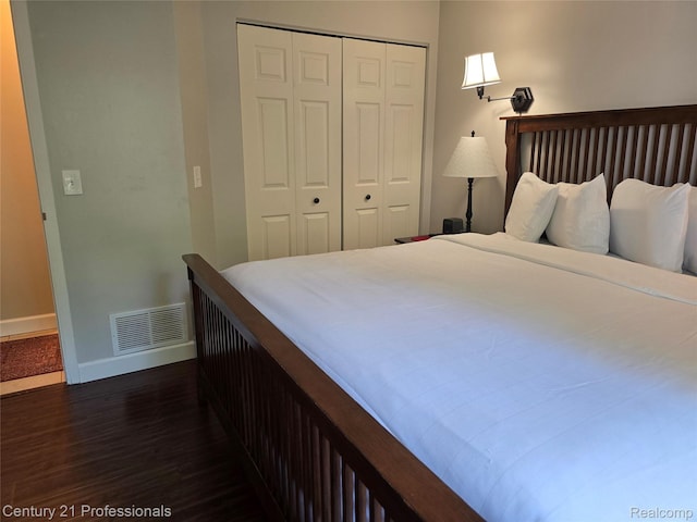 5714 N Creeks Xing, Williamsburg, MI 49690 - bedroom featuring dark wood-type flooring, a closet, and baseboards