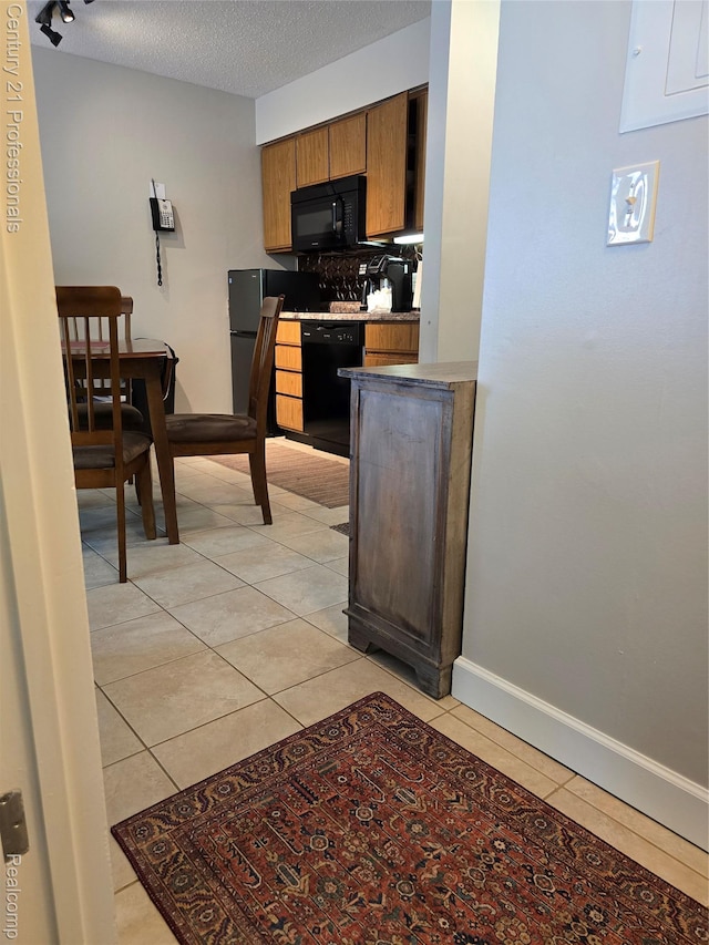 5714 N Creeks Xing, Williamsburg, MI 49690 - kitchen with black appliances, light tile patterned flooring, brown cabinets, electric panel, and a textured ceiling