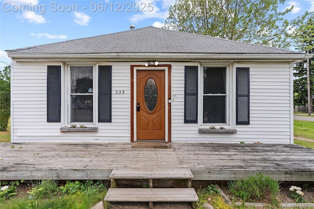 335 Main St, Morrice, MI 48857 - bungalow-style house with roof with shingles and a deck