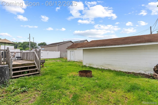 335 Main St, Morrice, MI 48857 - view of yard with a wooden deck and an outdoor fire pit