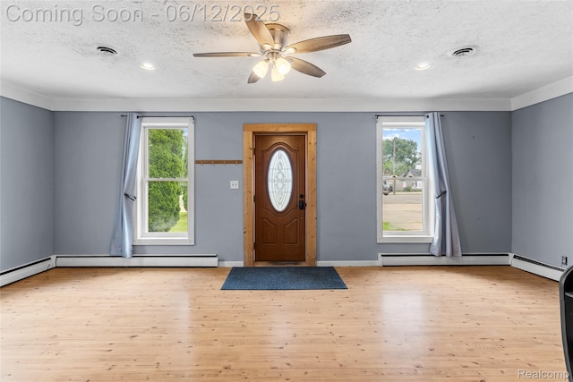 335 Main St, Morrice, MI 48857 - foyer featuring a textured ceiling, plenty of natural light, wood finished floors, a ceiling fan, and recessed lighting