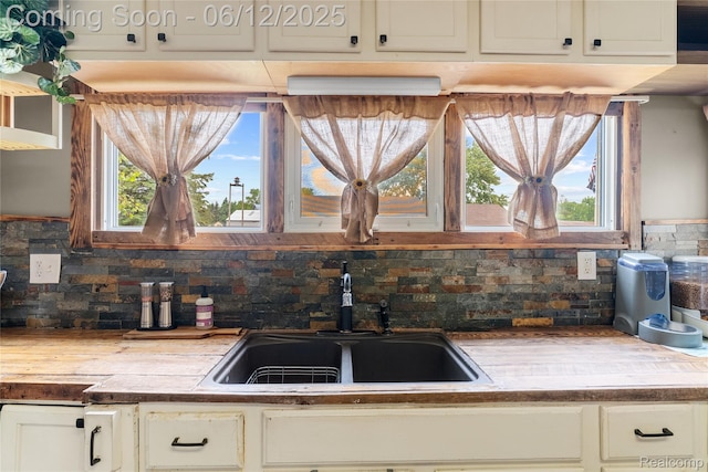 335 Main St, Morrice, MI 48857 - kitchen with a sink, tasteful backsplash, and healthy amount of natural light