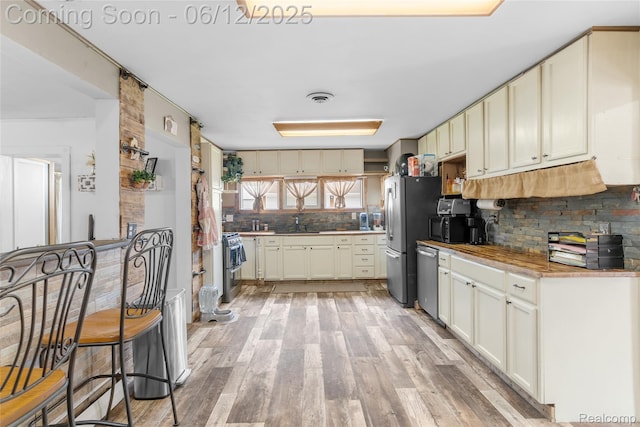 335 Main St, Morrice, MI 48857 - kitchen with tasteful backsplash, stainless steel appliances, and light wood-type flooring