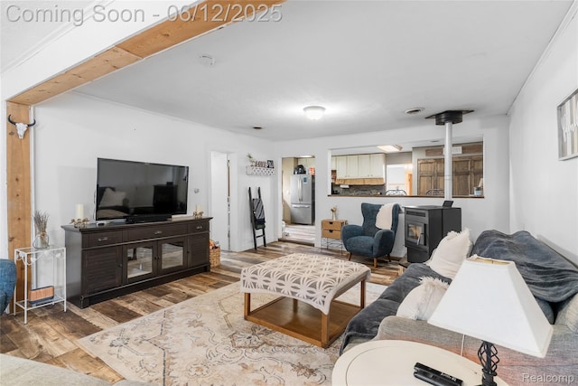 335 Main St, Morrice, MI 48857 - living area featuring wood finished floors and a wood stove