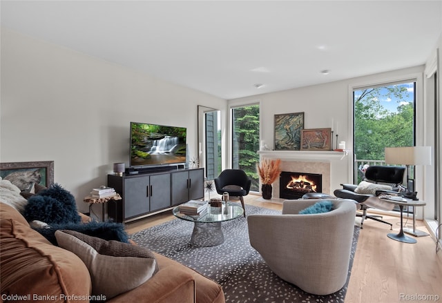 916 Tartan Trl, Bloomfield Hills, MI 48304 - living room featuring wood finished floors, a lit fireplace, and plenty of natural light