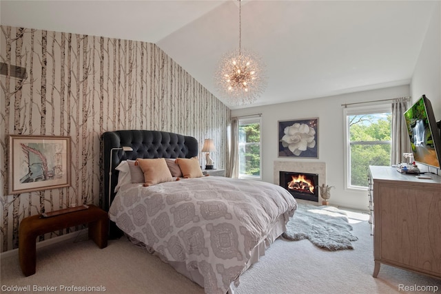 916 Tartan Trl, Bloomfield Hills, MI 48304 - bedroom with a chandelier, light colored carpet, lofted ceiling, wallpapered walls, and a warm lit fireplace