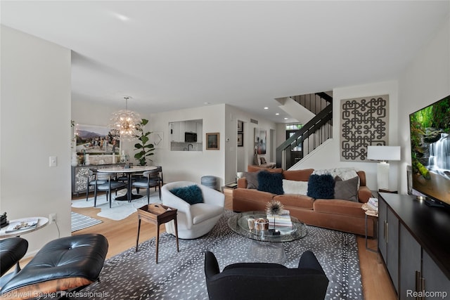 916 Tartan Trl, Bloomfield Hills, MI 48304 - living room with light wood finished floors, stairway, and a chandelier