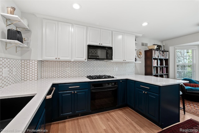 916 Tartan Trl, Bloomfield Hills, MI 48304 - kitchen featuring black appliances, open shelves, blue cabinetry, a peninsula, and white cabinetry