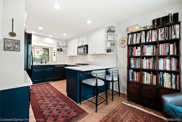 916 Tartan Trl, Bloomfield Hills, MI 48304 - kitchen featuring open shelves, black appliances, backsplash, white cabinetry, and light wood-type flooring