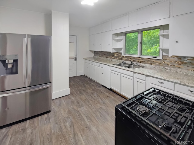 1505 Downey St, Flint, MI 48503 - kitchen featuring stainless steel refrigerator with ice dispenser, open shelves, a sink, gas range oven, and backsplash