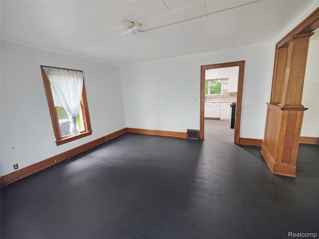 1505 Downey St, Flint, MI 48503 - unfurnished room with baseboards and dark wood-style floors