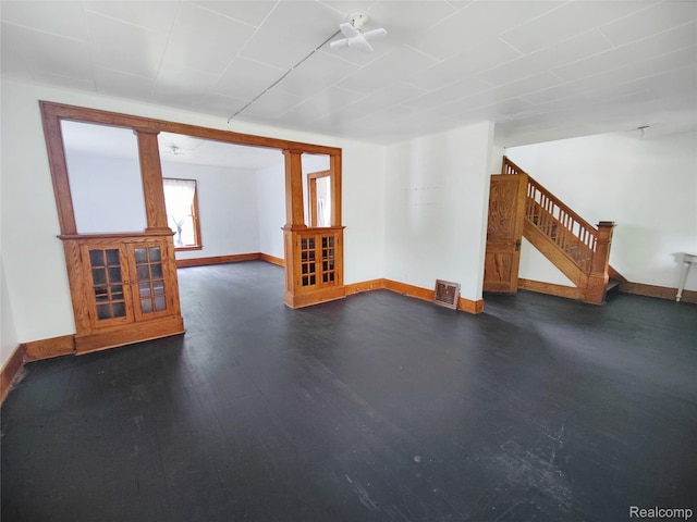 1505 Downey St, Flint, MI 48503 - unfurnished living room with stairway, baseboards, and dark wood-type flooring