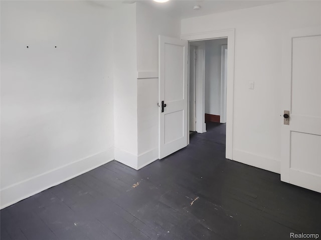 1505 Downey St, Flint, MI 48503 - empty room featuring dark wood finished floors and baseboards