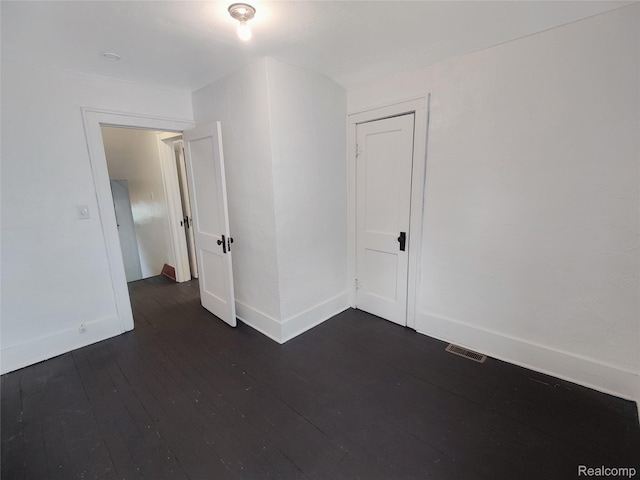 1505 Downey St, Flint, MI 48503 - empty room with dark wood-type flooring and baseboards