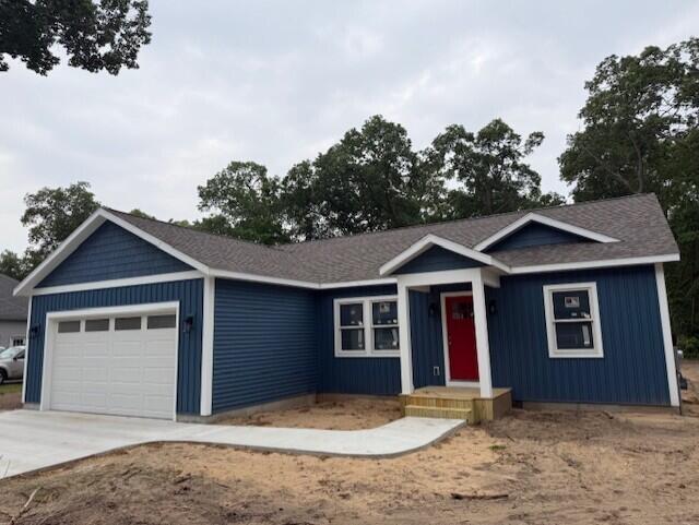 1243 Marquette Ave, Muskegon, MI 49442 - ranch-style home with an attached garage and concrete driveway