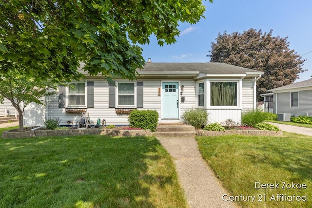 4246 Flamingo Ave SW, Wyoming, MI 49509 - view of front of property with central AC unit and a front yard