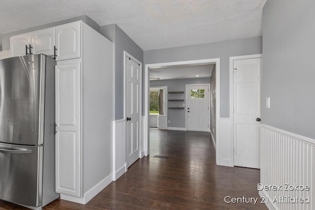 4246 Flamingo Ave SW, Wyoming, MI 49509 - kitchen with freestanding refrigerator, white cabinetry, dark wood-style floors, a textured ceiling, and wainscoting