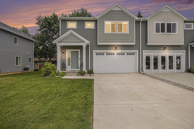 1047 Rebecca St, Marshall, MI 49068 - view of front of property featuring driveway, a lawn, an attached garage, and central AC unit