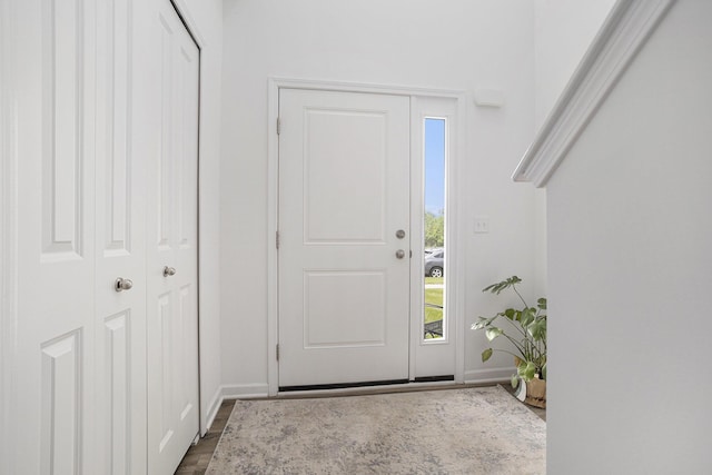 1047 Rebecca St, Marshall, MI 49068 - entryway with baseboards and dark wood-style flooring
