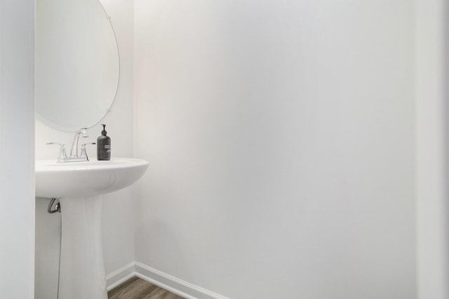 1047 Rebecca St, Marshall, MI 49068 - bathroom with baseboards, wood finished floors, and a sink