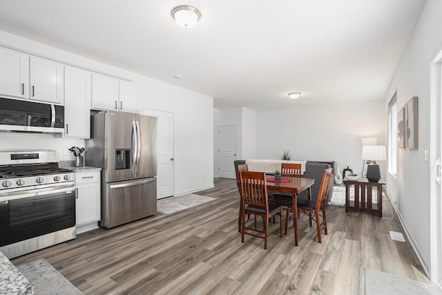 1047 Rebecca St, Marshall, MI 49068 - dining space featuring light wood-style flooring and baseboards