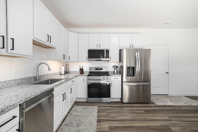 1047 Rebecca St, Marshall, MI 49068 - kitchen featuring stainless steel appliances, a sink, dark wood-type flooring, and light stone counters