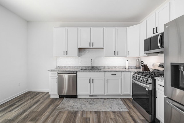 1047 Rebecca St, Marshall, MI 49068 - kitchen with appliances with stainless steel finishes, a sink, light stone counters, and white cabinets