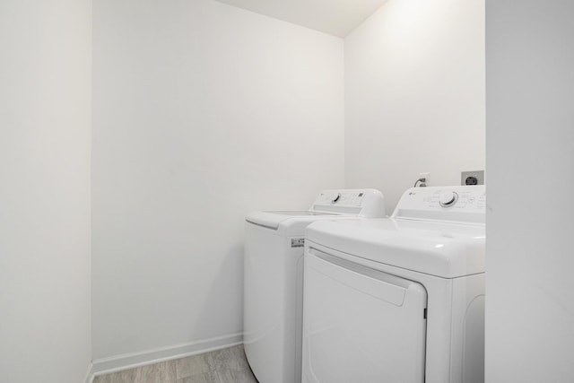 1047 Rebecca St, Marshall, MI 49068 - washroom with separate washer and dryer, baseboards, and light wood-type flooring