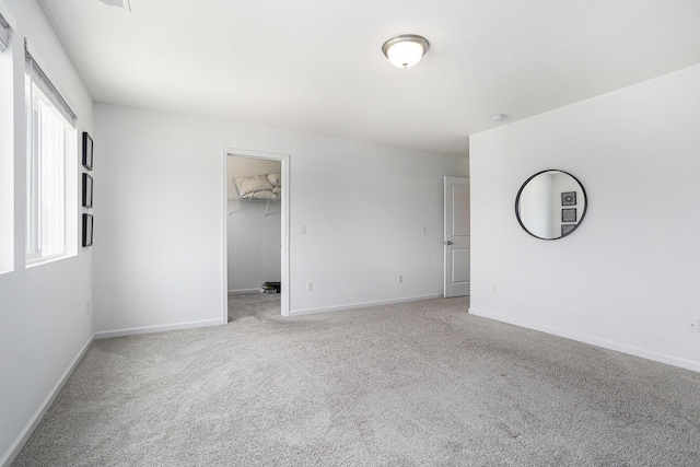 1047 Rebecca St, Marshall, MI 49068 - spare room featuring light colored carpet and baseboards