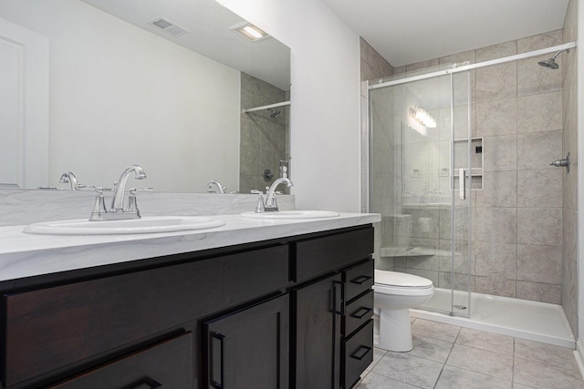 1047 Rebecca St, Marshall, MI 49068 - bathroom with double vanity, toilet, a stall shower, and tile patterned flooring