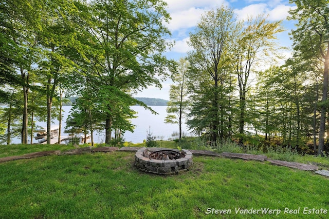 5185 W Nurnberg Rd, Michigan, MI 49411 - view of grassy yard with a fire pit and a water view