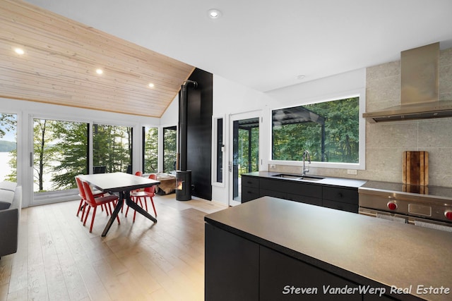 5185 W Nurnberg Rd, Michigan, MI 49411 - kitchen with a sink, wall chimney exhaust hood, dark cabinets, decorative backsplash, and recessed lighting
