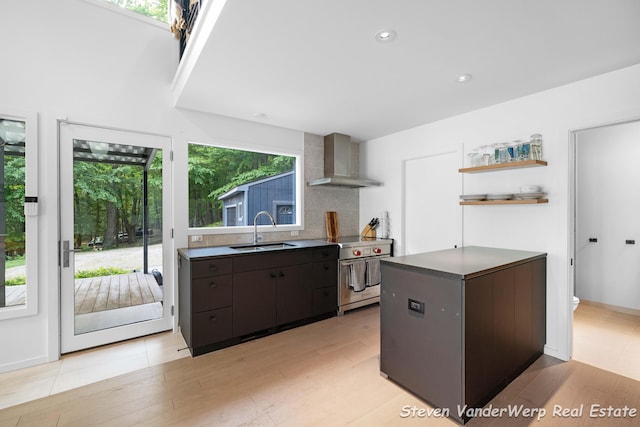 5185 W Nurnberg Rd, Michigan, MI 49411 - kitchen featuring wall chimney exhaust hood, a sink, stainless steel electric range oven, light wood-type flooring, and tasteful backsplash