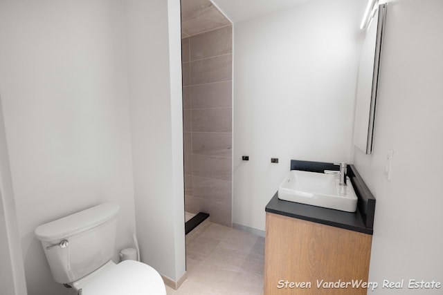 5185 W Nurnberg Rd, Michigan, MI 49411 - full bath with toilet, vanity, a tile shower, and tile patterned flooring