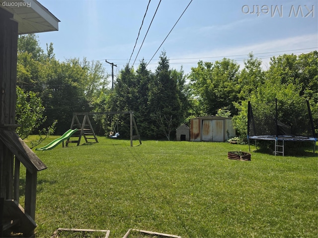 29827 Oakwood St, Inkster, MI 48141 - view of green lawn with a trampoline and a playground