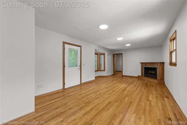 1616 Catalpa Dr, Royal Oak, MI 48067 - unfurnished living room featuring light wood-style floors, a fireplace with raised hearth, and recessed lighting