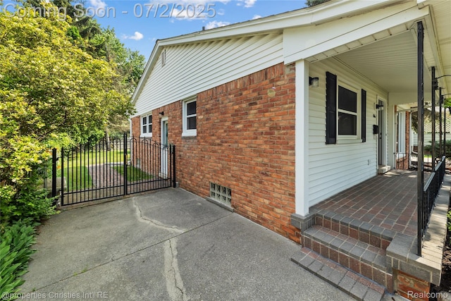 1616 Catalpa Dr, Royal Oak, MI 48067 - view of home's exterior featuring brick siding, a porch, and a gate