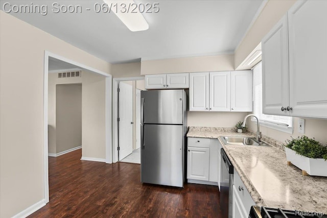 9243 Cornell St, Plymouth, MI 48180 - kitchen featuring stainless steel appliances, white cabinets, dark wood-type flooring, and light stone countertops