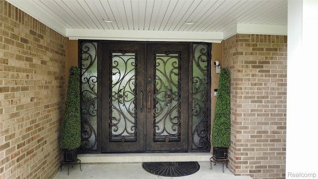 5084 Champlain Cir W, Bloomfield, MI 48323 - view of exterior entry with french doors and brick siding