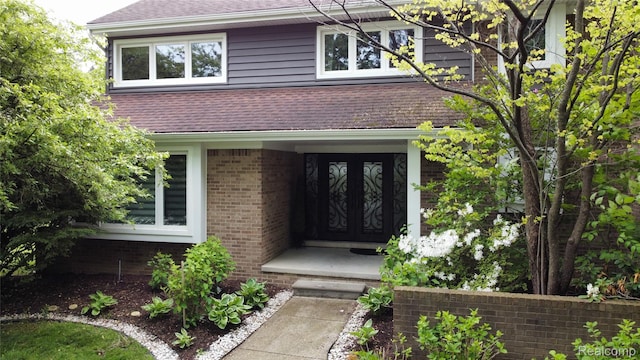 5084 Champlain Cir W, Bloomfield, MI 48323 - view of exterior entry with a shingled roof and brick siding
