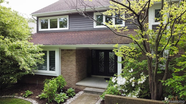 5084 Champlain Cir W, Bloomfield, MI 48323 - view of front of property with a shingled roof, french doors, and brick siding